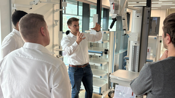 Employee shows a customer a product part