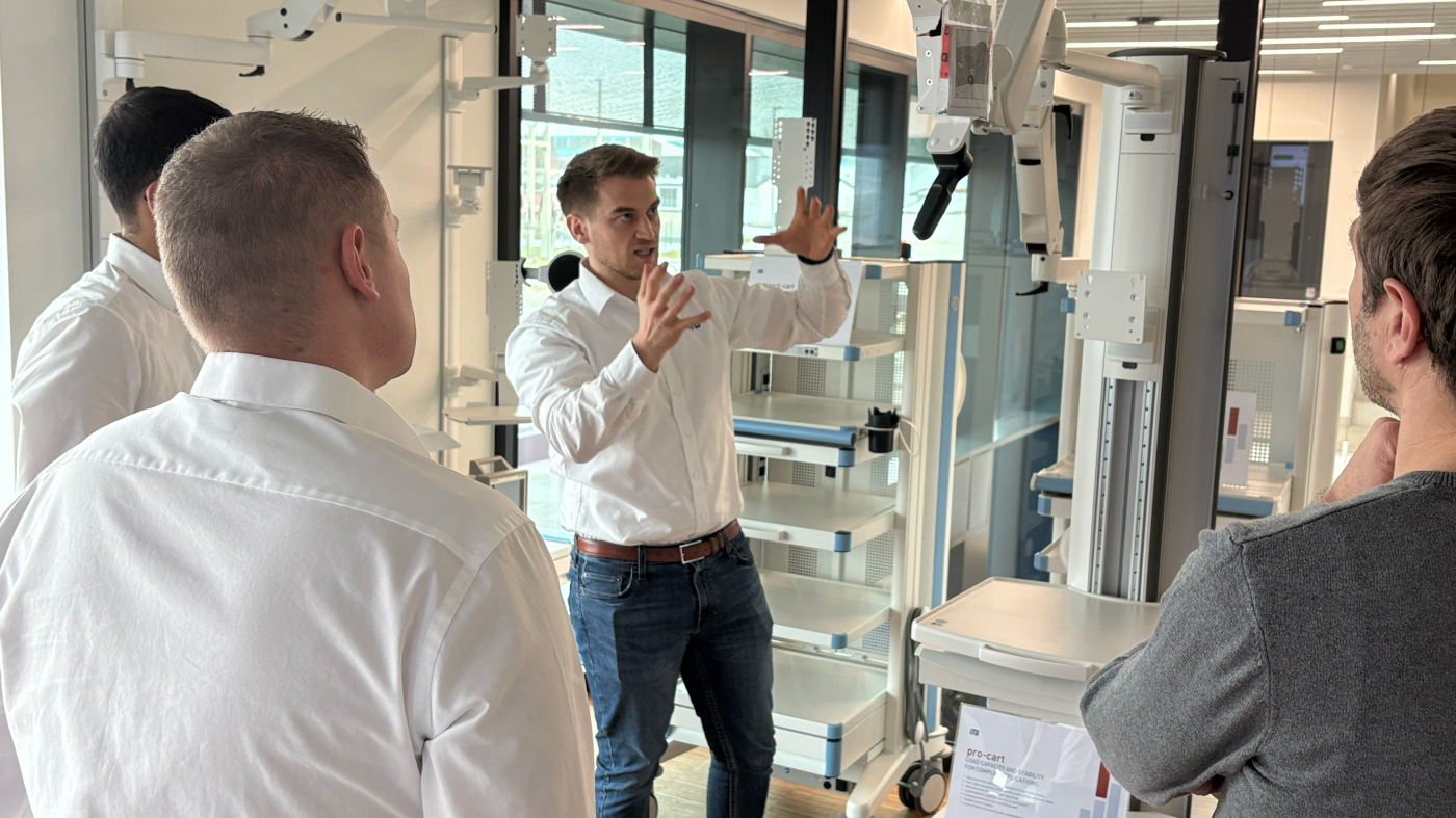 Employee shows a customer a product part