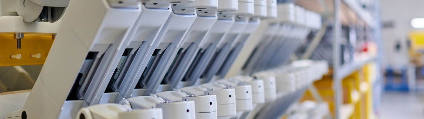 A row of medical mounting arms in a production facility