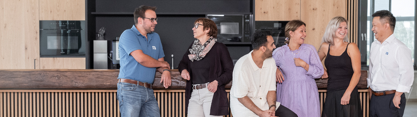 A diverse group of people smiling and talking