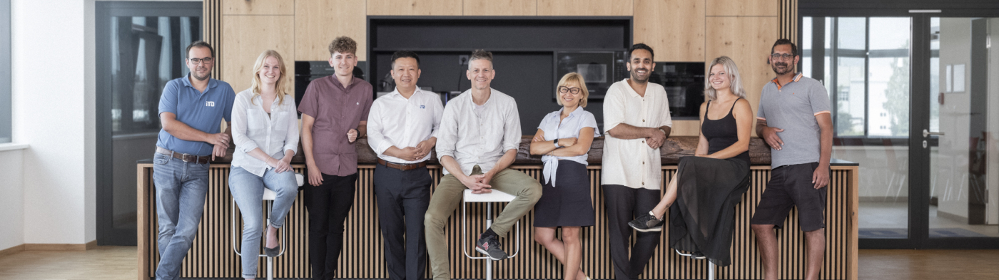 Multi-cultural team meeting and working together at table